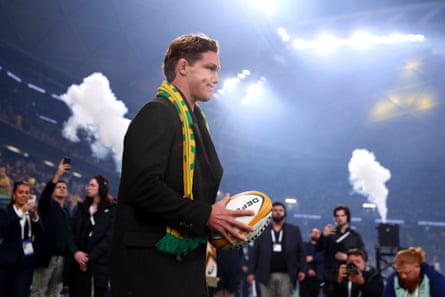 Michael Hooper takes to the field with the match ball as he was honoured in Sydney.