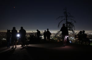 Los Angeles, US. People take in the view of the total lunar eclipse creating the super blood moon from Griffith Park