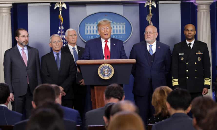 Donald Trump speaks about the coronavirus with Alex Azar, health and human services secretary; Dr Anthony Fauci, National Institute for Allergy and Infectious Diseases director; Mike Pence, vice-president; Robert Redfield, director of the CDC; and Dr Jerome Adams, the US surgeon general.