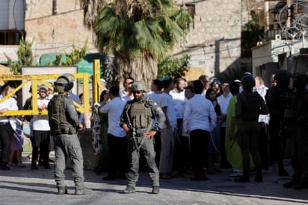 Israeli settlers on a weekly tour in Hebron, escorted by security forces.