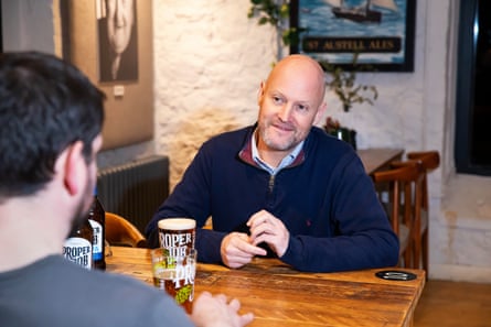 Two men facing each other across a restaurant table