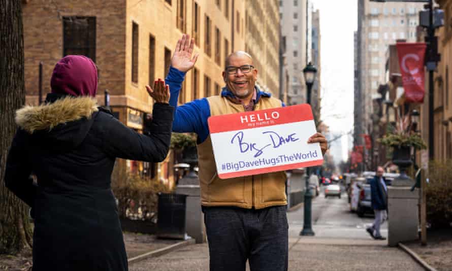 David Sylvester high-fives a passerby in Philadelphia, Pennsylvania, where he lives.