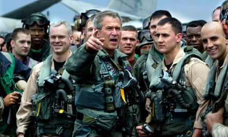 President George W Bush meets with crew members on the deck of the aircraft carrier USS Abraham Lincoln.