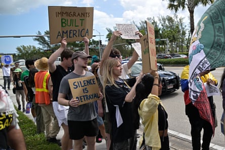 people hold signs in support of immigrants