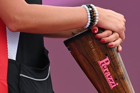 A woman’s arms rest on a gun