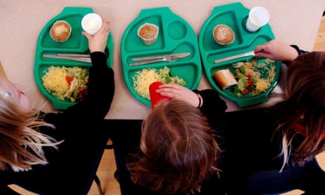 Three girls eating school lunch, seen from above