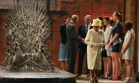 Queen Elizabeth admires the iron throne on a visit to the set of Game of Thrones in Northern Ireland.