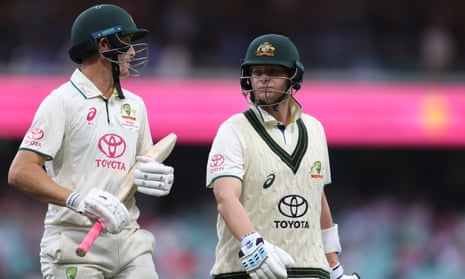 Marnus Labuschagne and Steve Smith walk off the field as play is suspended due to bad light in the third Test at the SCG