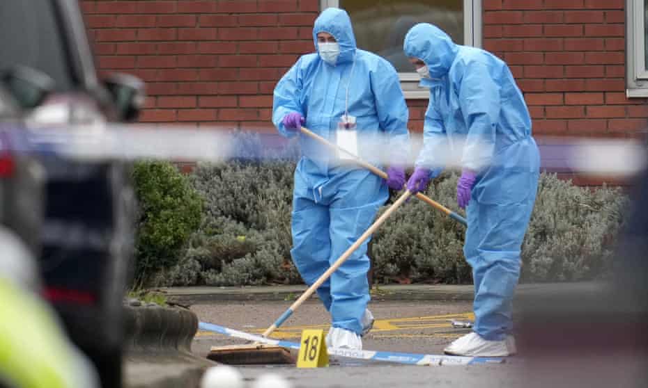 Police officers continue their forensic investigations at the scene of the car explosion at Liverpool Women's hospital