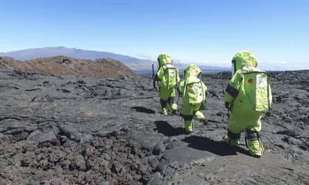 Members of Mission V walk across lava at the Mauna in Hawaii