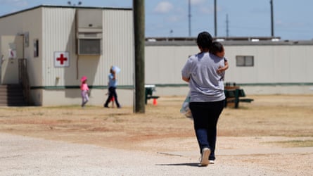 A female carries a kid extracurricular astatine nan installation successful Dilley, Texas