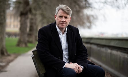 Chris Skidmore sitting for a photograph on a park bench