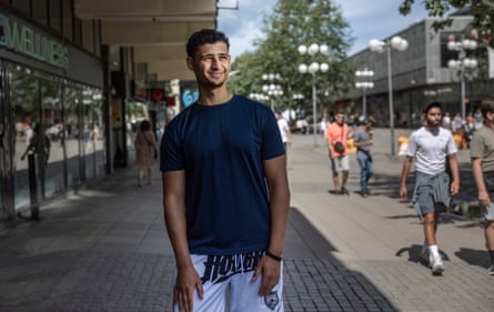 Ermias Balcha posing for a photo on a shopping street