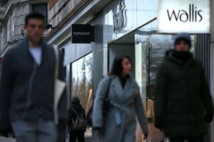 Pedestrians walk past closed-down Topshop and Wallis clothes stores in central London.