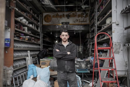 Erfan stands in his shop