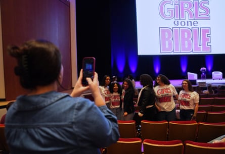 A person talks a photo at a Girls Gone Bible event