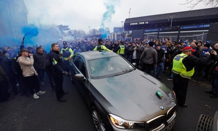 A car containing Delia Smith and Norwich City directors, with a police escort, has a can of beer thrown on to its bonnet before a Championship match at Ipswich in December 2023.