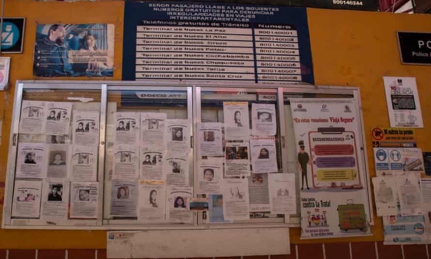 Large board with posters of missing women plastered all over.