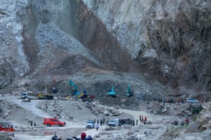 Rescuers and rescue vehicles in the bottom of an open quarry