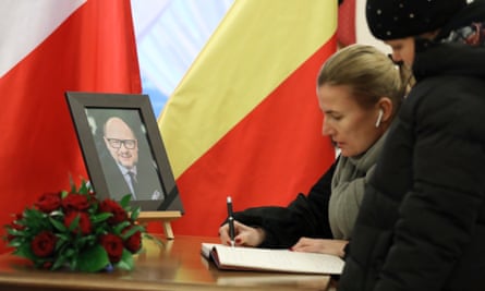 Woman signs book of condolence for Pawel Adamowicz in Warsaw
