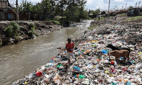 A boy picks waste at a dump in Kenya