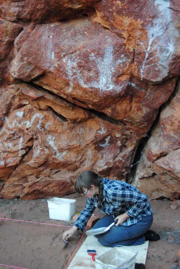 Archaeologist studies a rock shelter in the Western Desert