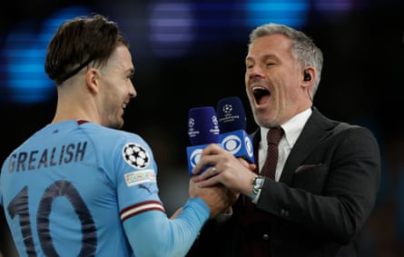 Jack Grealish of Manchester City jokes with Jamie Carragher after an interview with CBS TV at the Etihad Stadium in May 2023.