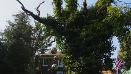 Silver baubles hanging from a tree.