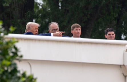 four men stand on roof