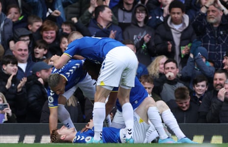 Everton's Anthony Gordon (on ground) celebrates scoring their first goal with team-mates.