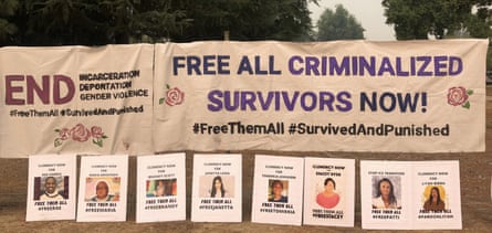 ‘Free all criminalized survivors now!’ on a banner with posters with people’s photos underneath