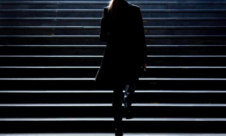 Silhouette of a woman walking up some stairs