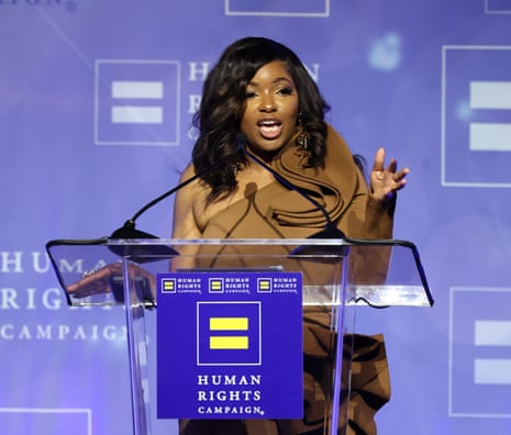 A woman with black wavy hair speaks at a lectern for a Human Rights Campaign event