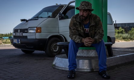 An injured soldier suffering from hearing difficulties due to shelling sits in a petrol station in Pokrovsk.
