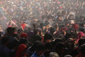 Well-wishers brave the rain as they gather at the residence of Indonesian Vice President Jusuf Kalla