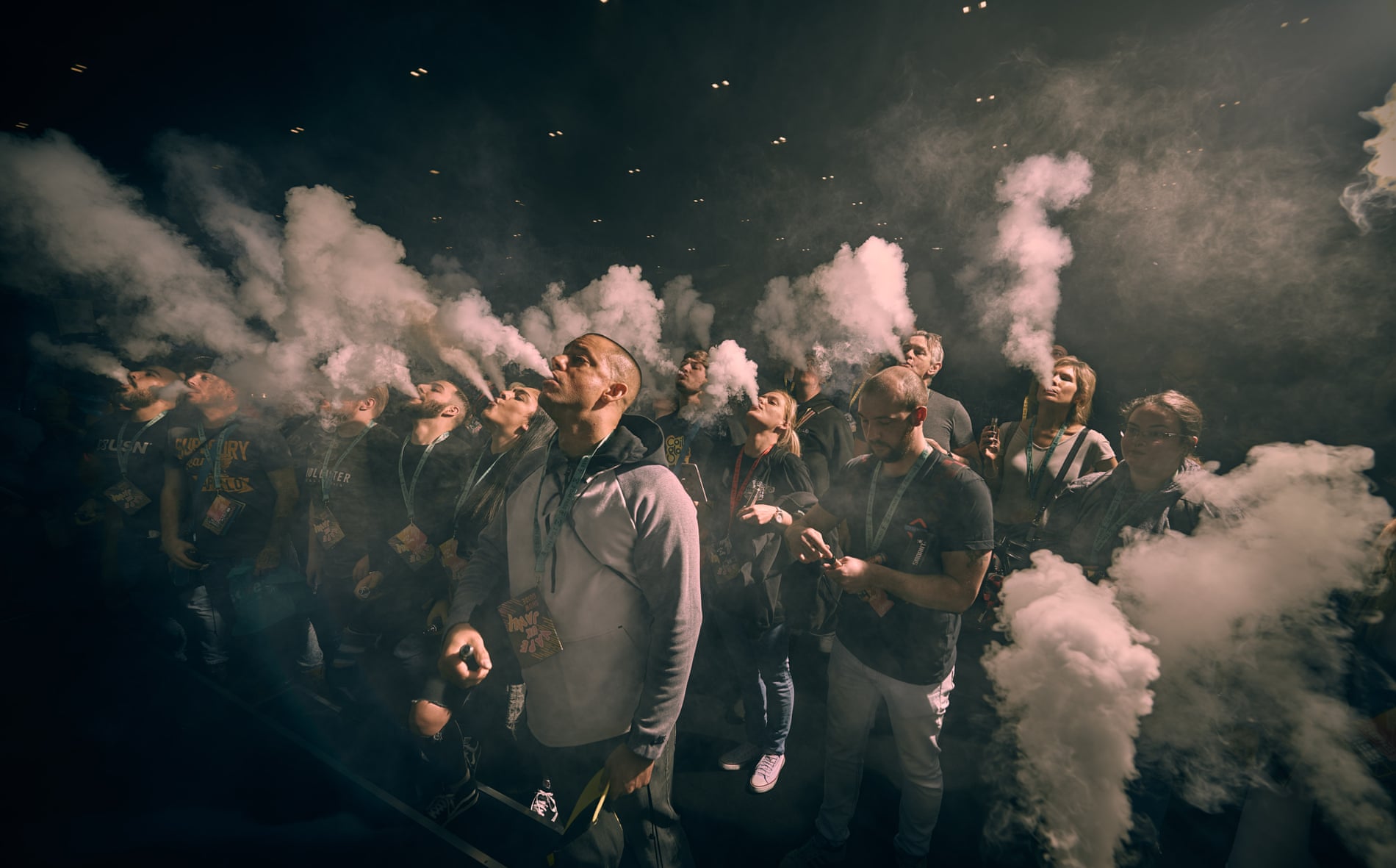 Participants exhale in unison at a mass vape at the trade fair Vape Jam in London, in April 2018