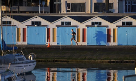 A runner runs past the boat sheds on Oriental Parade at 7.30am, Friday during Level 4 lockdown for the COVID-19 pandemic in Wellington COVID-19 pandemic lockdown, Wellington, New Zealand - 20 Aug 2021