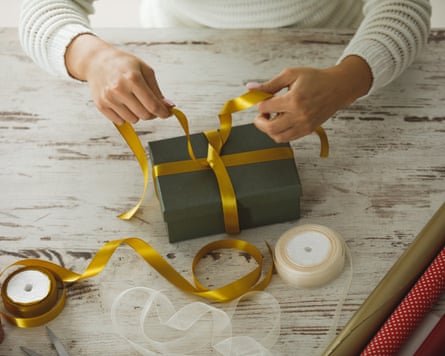 person wrapping a present