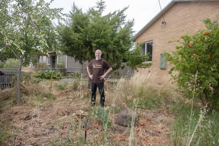 Man standing in scruffy lawn