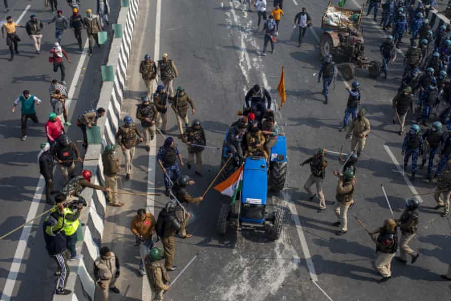 Police beat farmers driving a tractor towards the heart of Delhi on 26 January.