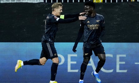 Bukayo Saka celebrates with Martin Ødegaard after scoring for Arsenal