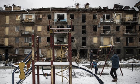 A child swings at park in front of damaged residential building due to airstrikes as Russia-Ukraine war continues in Vyshorod, Kyiv Oblast, Ukraine on November 30, 2022.