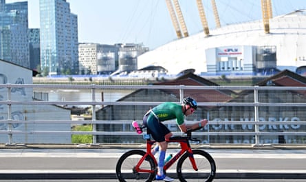 A man cycling past the 02 arena in 2025.