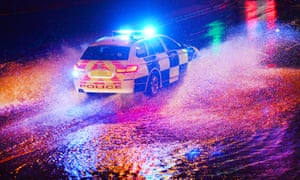 A Bedfordshire police BMW 4 x 4 on an emergency call charges through flash flooding in Church Street on July 18, 2017 in Dunstable, England