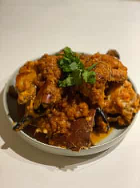 Adam Liaw stirs the gooey innards of the crab into the sauce to enrich it.