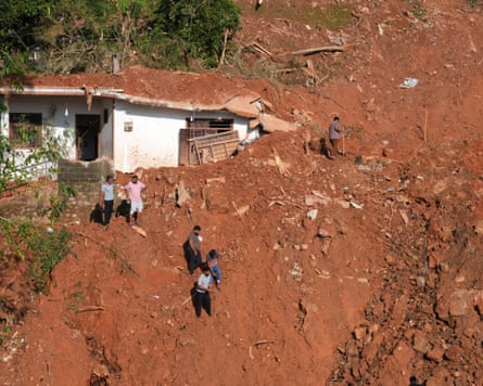 People look for survivors and lost belongings after a landslide in Kandy, Sri Lanka