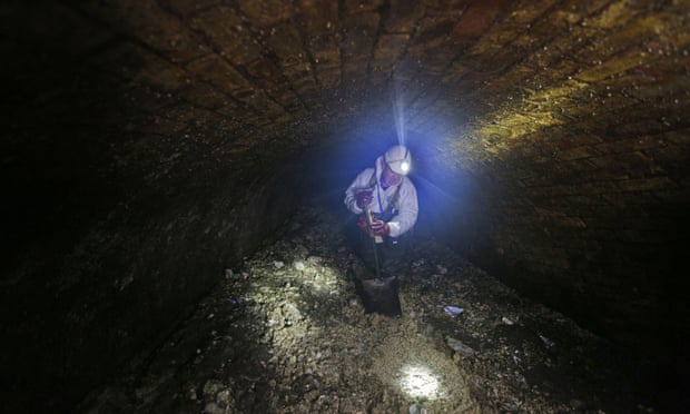 a Thames Water sewer supervisor unblocks a sewer in central London.