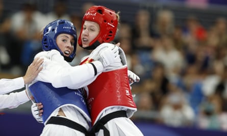 Jade Jones (left) fights Miljana Reljikj (right) in her first-round taekwondo match