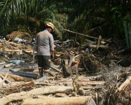 A view of the destruction among the wooden debris affected by flash floods as the search and rescue operations continue in Batang Toru District, South Tapanuli Regency, North Sumatra, Indonesia