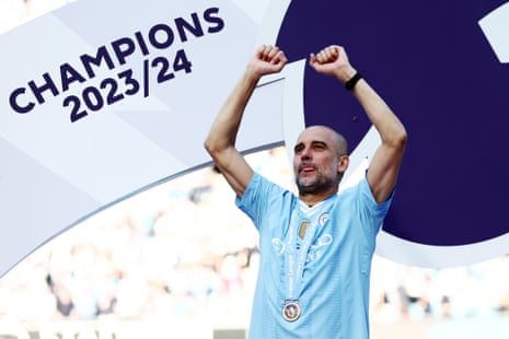Pep Guardiola celebrates with his winner’s medal.